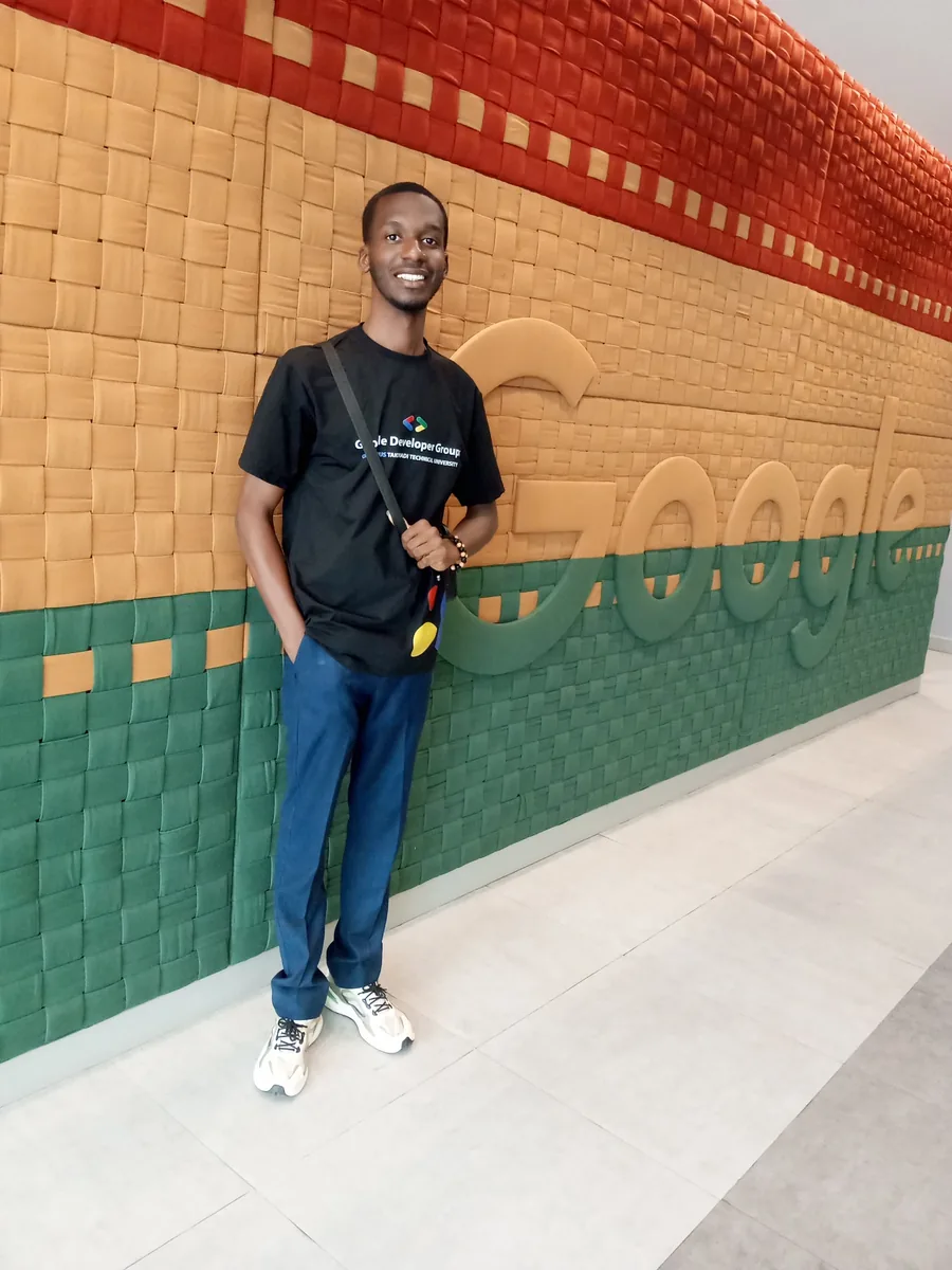 Leonard in a GDG shirt in front of a Google-branded wall