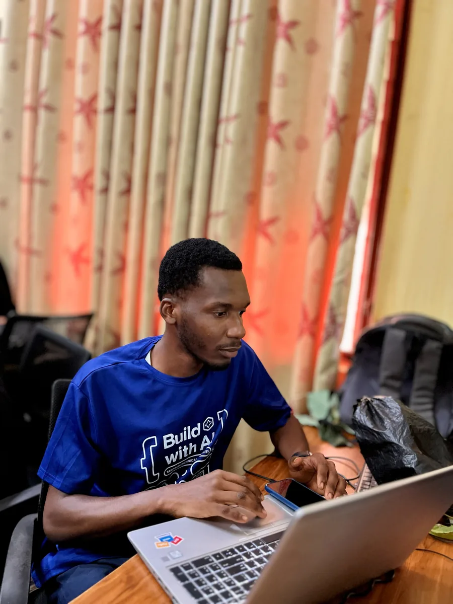 Working on a laptop at the Build with Gemma 4 AI Hackathon