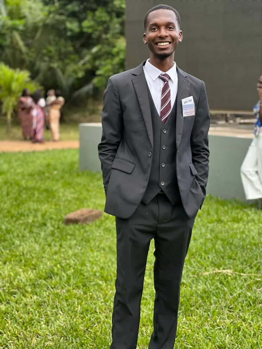 Leonard in a suit, smiling