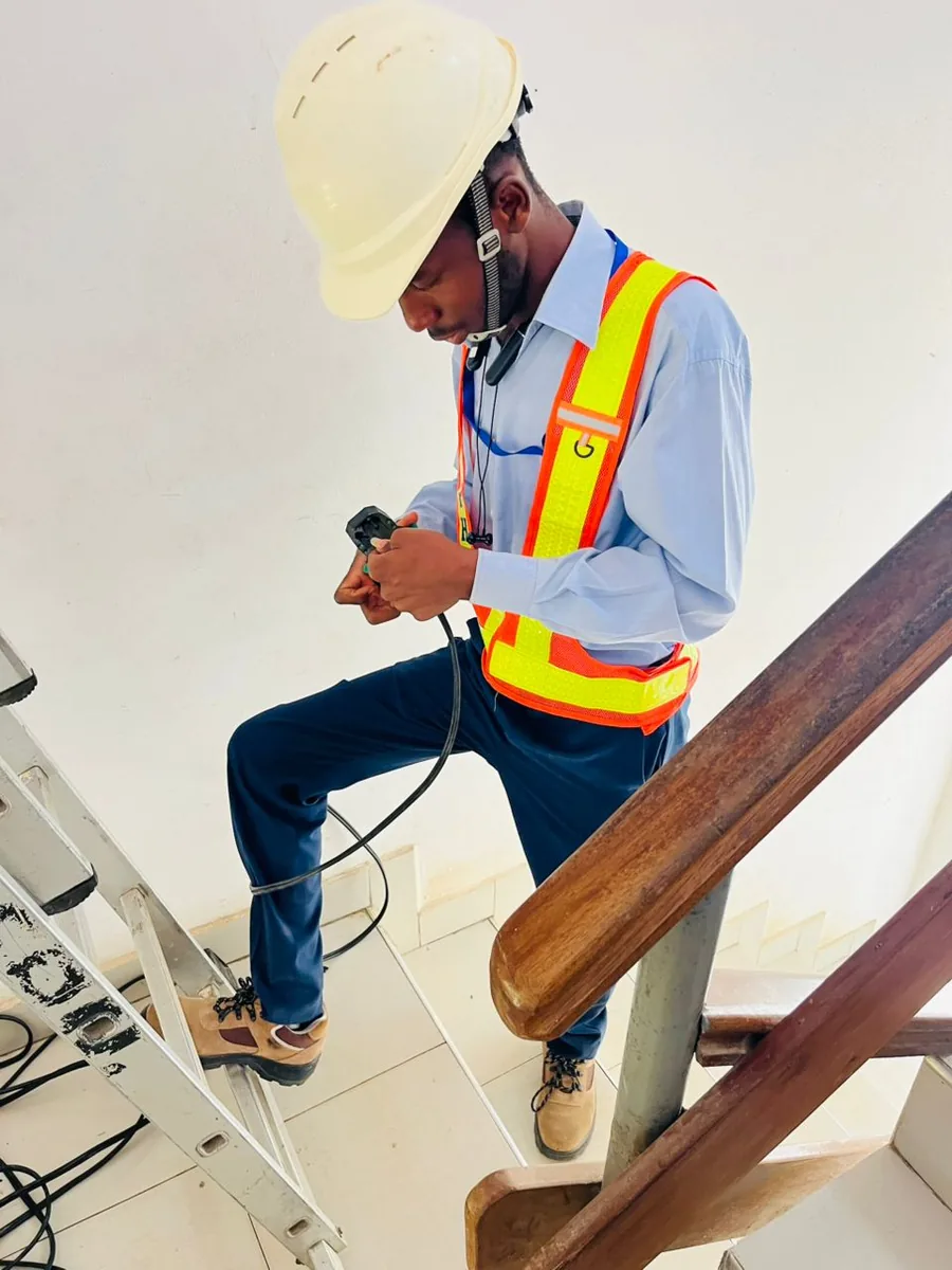 On site in a hard hat with test equipment